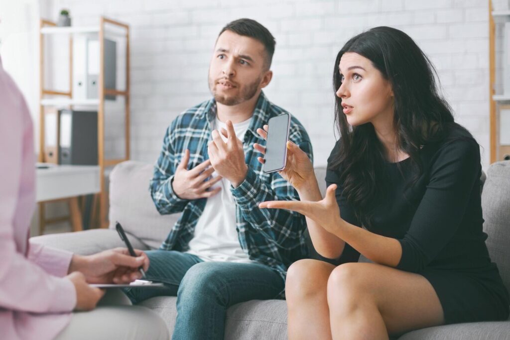 young couple sits couch therapy session they are discussing their smartphone usage 116547 126817 young couple sits couch therapy session they are discussing their smartphone usage 116547 126817