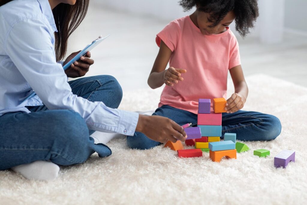cropped kid child psychotherapist playing with bricks 116547 17368 cropped kid child psychotherapist playing with bricks 116547 17368