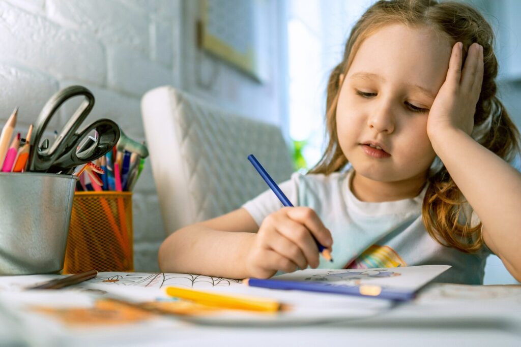 cute little girl paints picture with colored pencils child draws coloring book 127093 1738